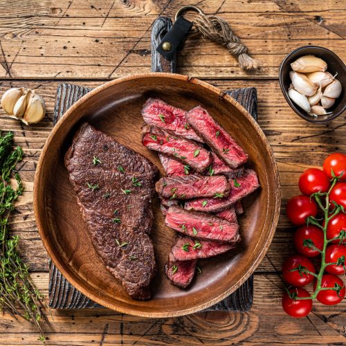 grilled-sliced-top-blade-or-denver-beef-meat-steak-in-a-wooden-plate-with-herbs-.jpg
